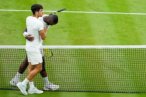 Carlos Alcaraz embraces Francis Tiafoe